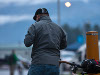 Man with cycle leaned up against bollard