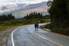 cyclists riding on wet roadway